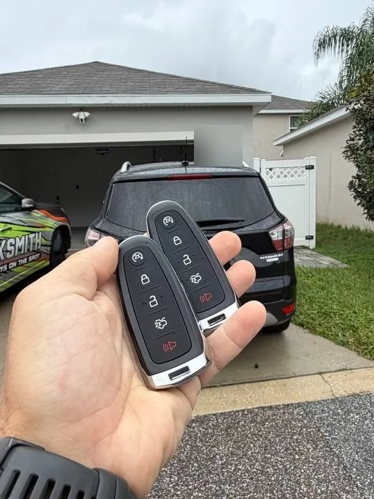 Two programmed Ford smart keys in front of the customer's SUV